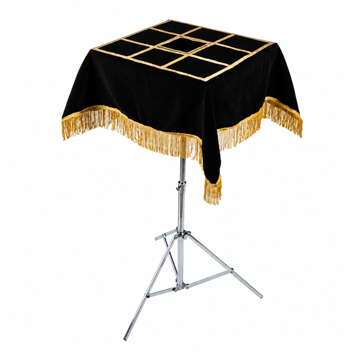 Magicians Table top with black velvet and gold fringe on a white background